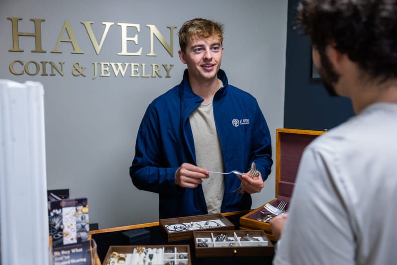 Evaluating items at the Haven Coin & Jewelry counter in Hamden, CT, serving orange