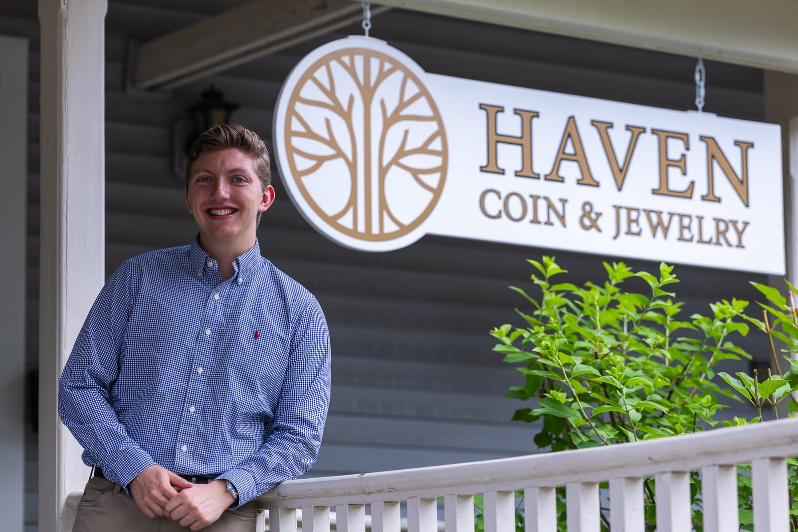 Haven Coin & Jewelry owner standing in front of store sign