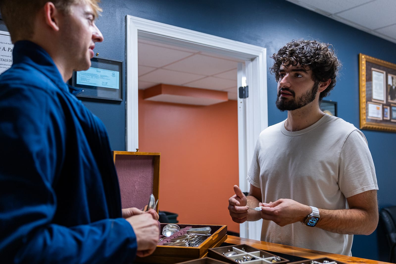 Haven Coin & Jewelry staff consulting with customer on silverware appraisal