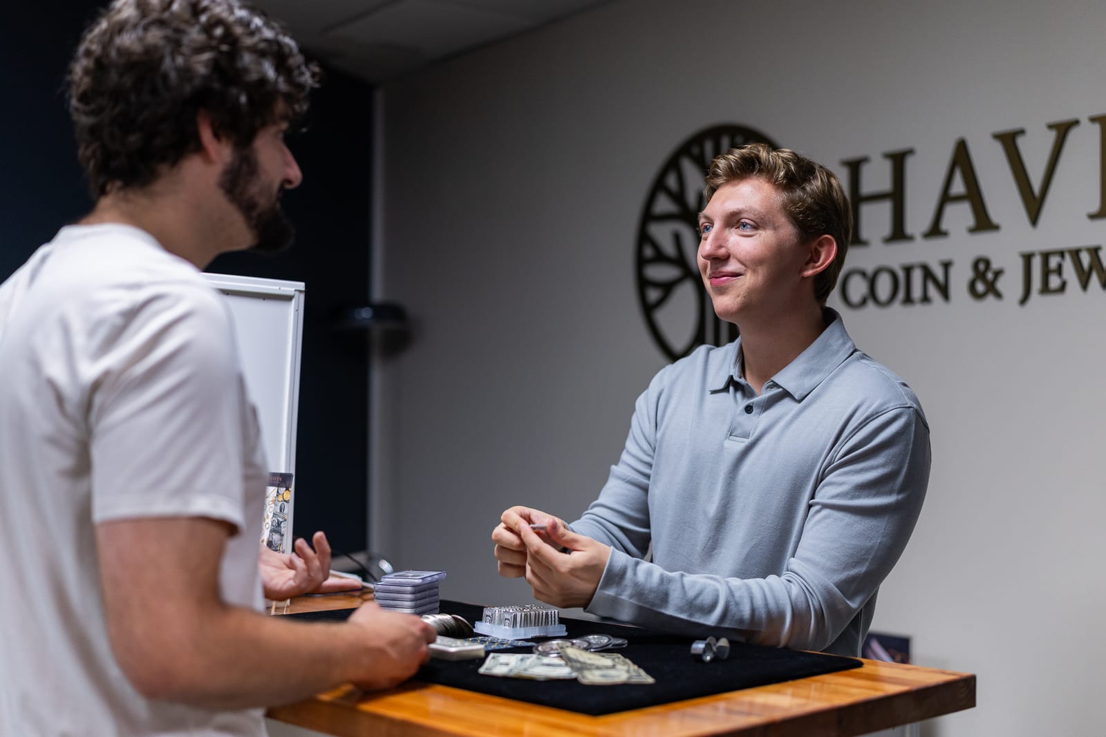 Coin dealer consulting with customer about their collection at Haven Coin & Jewelry, Hamden CT
