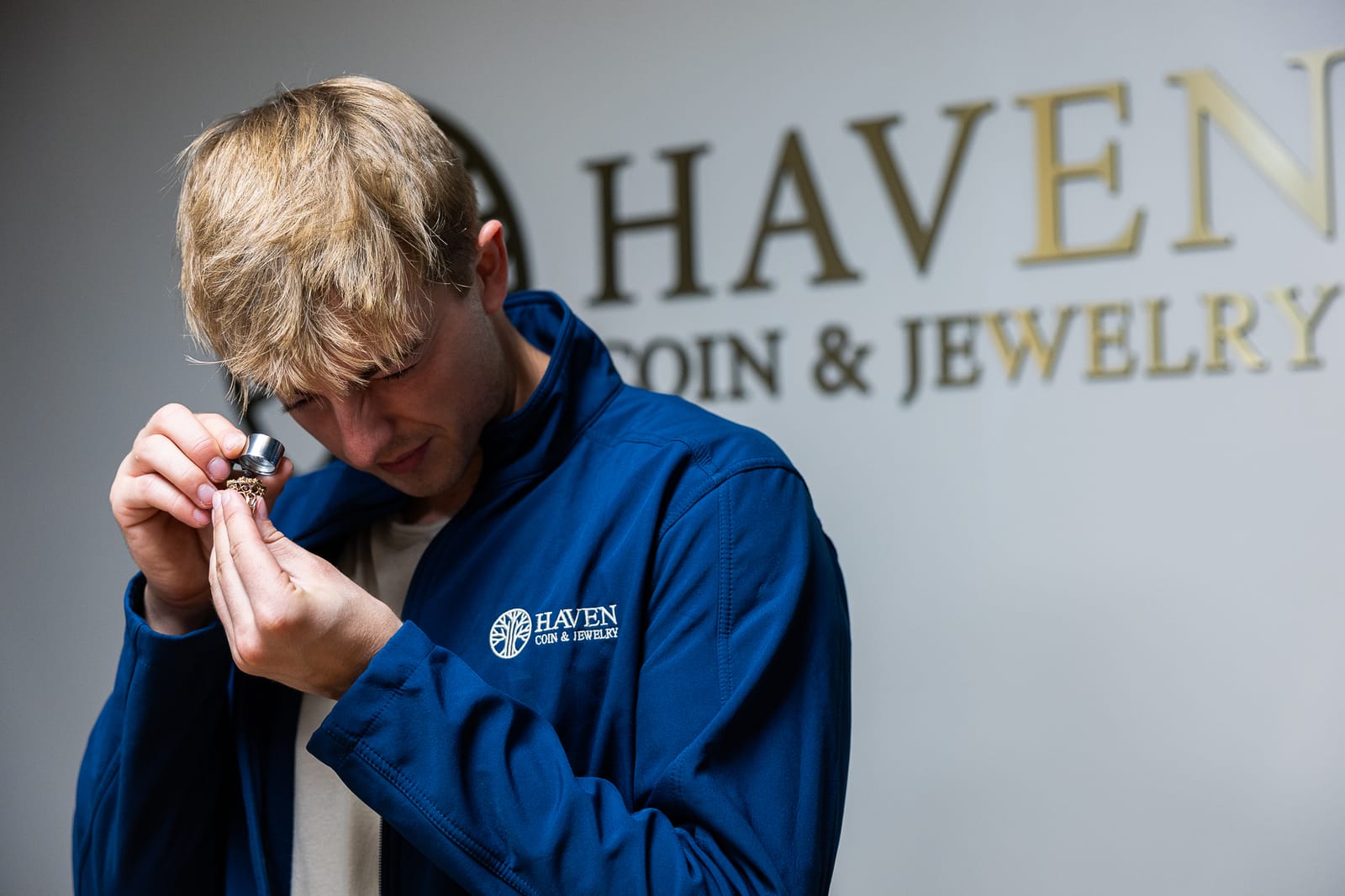 Haven Coin & Jewelry dealer inspecting jewelry with loupe magnifier, Hamden CT